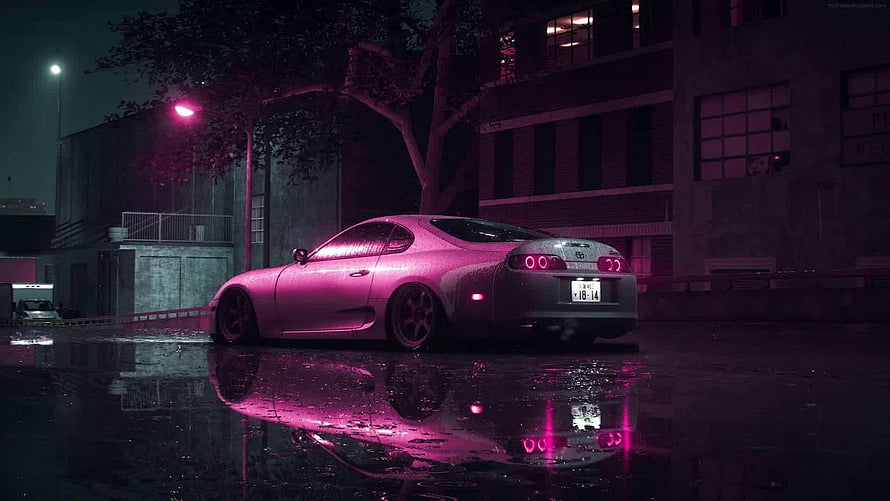 Neon-lit Toyota Supra parked on a wet city street at night with pink reflections HD wallpaper