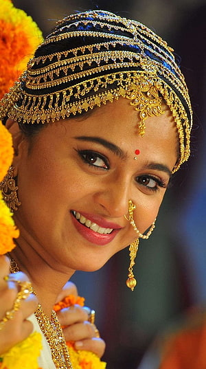 Anushka Shetty in Traditional South Indian Bridal Attire with Gold Jewelry and Marigold Garland HD phone wallpaper