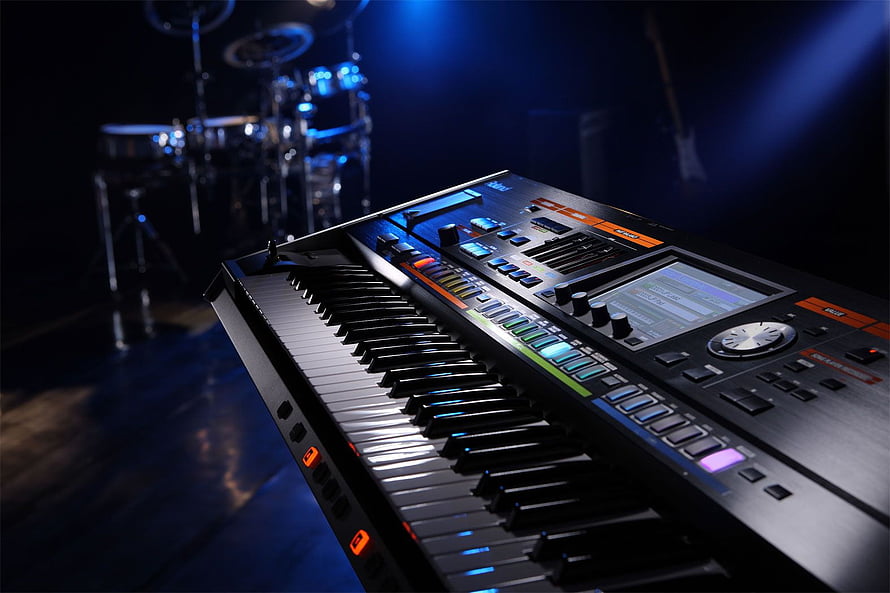 Roland Jupiter 80 Synthesizer on Stage with Blue Lighting and Drum Kit HD wallpaper