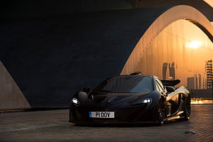 Black McLaren P1 Super Car Front View Under Arch at Sunset HD wallpaper