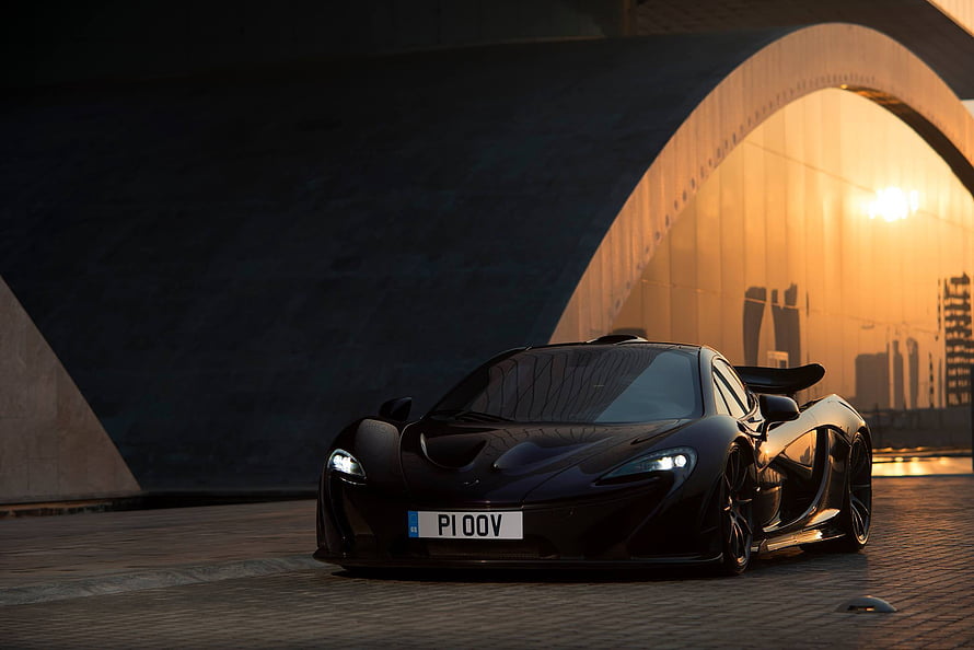 Black McLaren P1 Super Car Front View Under Arch at Sunset HD wallpaper