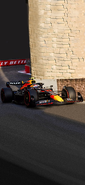 Sergio Perez Red Bull Racing Formula 1 Car Cornering at the Baku City Circuit HD phone wallpaper