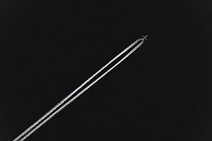 Minimalist Airplane Leaving Contrails in Dark Night Sky HD wallpaper