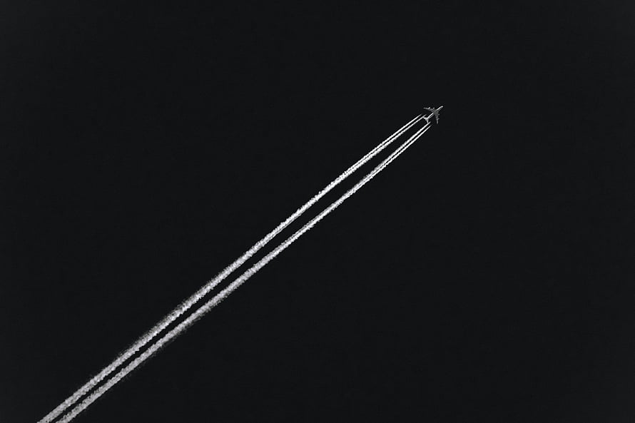 Minimalist Airplane Leaving Contrails in Dark Night Sky HD wallpaper