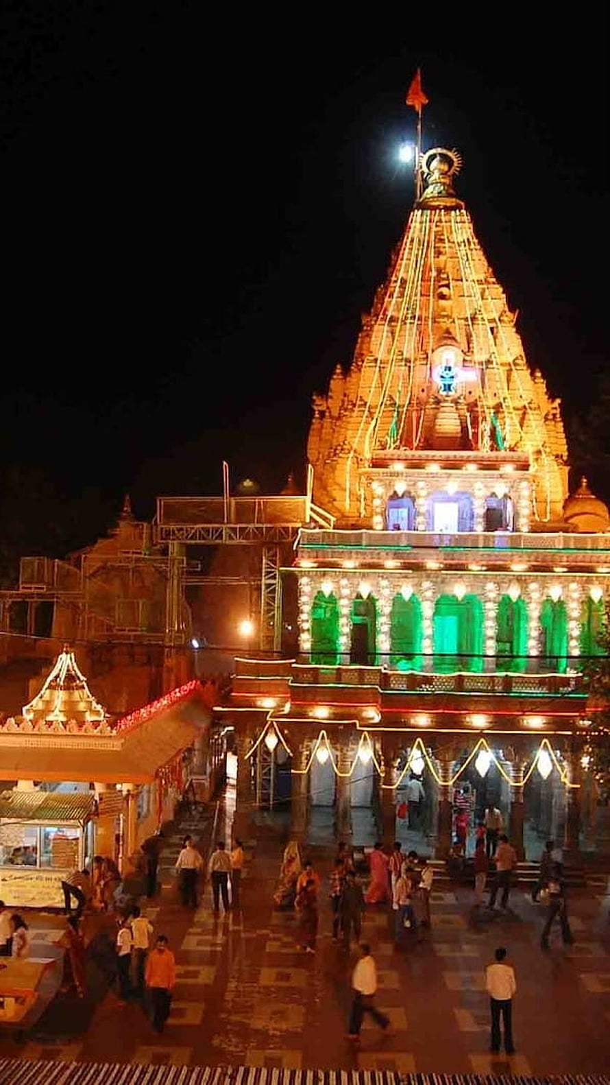 Mahakaleshwar Temple in Ujjain Illuminated at Night with Devotees in the Courtyard HD phone wallpaper