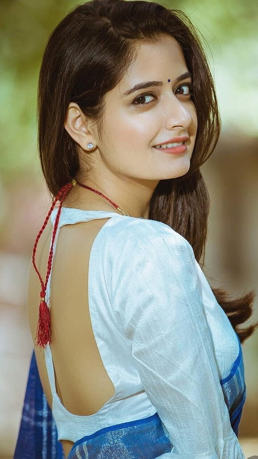 Ashika Ranganath in a White and Blue Saree with Red Tassel Necklace HD phone wallpaper