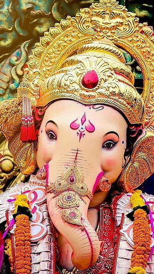 Ornate Lord Ganesha Murti with Golden Crown and Marigold Garlands HD phone wallpaper