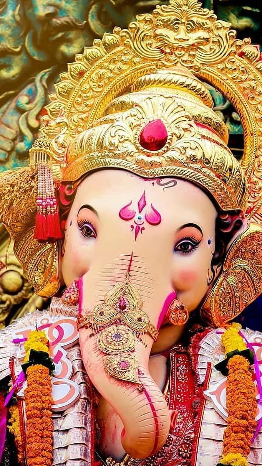 Ornate Lord Ganesha Murti with Golden Crown and Marigold Garlands HD phone wallpaper