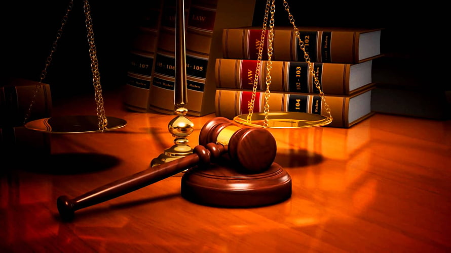 Wooden Gavel and Scales of Justice with Law Books on a Warm Wooden Desk HD wallpaper