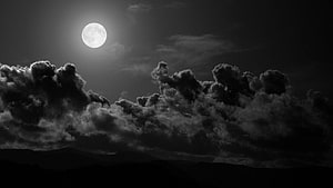 Monochrome Full Moon Rising Over Dramatic Clouds and Mountain Silhouettes HD wallpaper