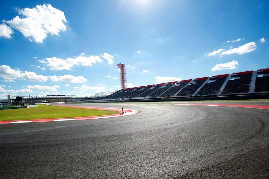 Empty Grand Prix Circuit With Grandstands And Control Tower Under Blue Sky HD wallpaper
