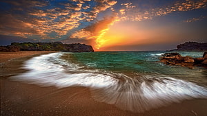 Golden Ocean Sunset Over Rocky Coastline With Turquoise Water And Soft Waves HD wallpaper