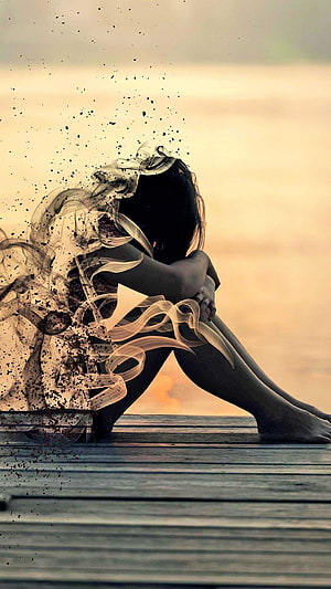 Silhouette of a woman sitting alone on a dock with a surreal dissolving effect against a warm sunset, Girl Sad Alone , Girl Sad Lonely HD phone wallpaper