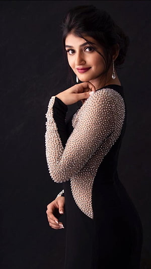 Elegant Portrait of Actress Pooja Hegde in a Black Gown with Pearl-Embellished Sleeves HD phone wallpaper
