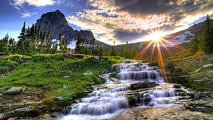 Majestic Mountain Waterfall at Sunset with Sunburst and Pine Forest HD wallpaper
