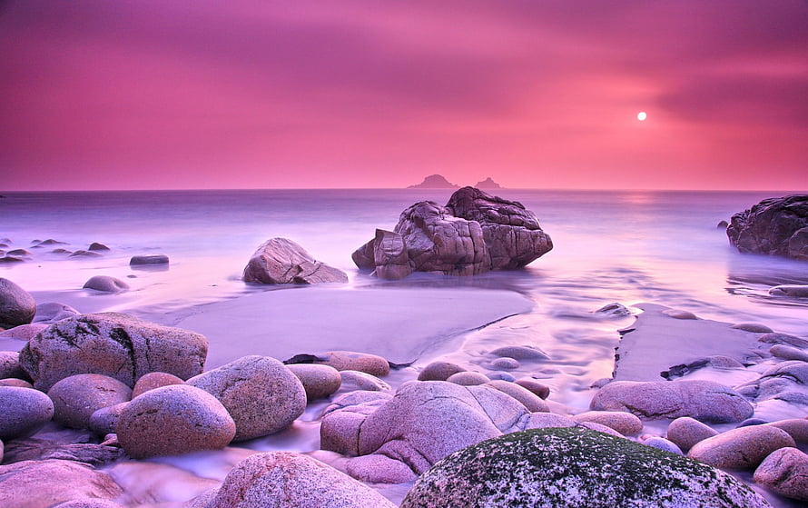 Pink Sunset Over Rocky Shoreline With Smooth Boulders And Calm Ocean Waters HD wallpaper