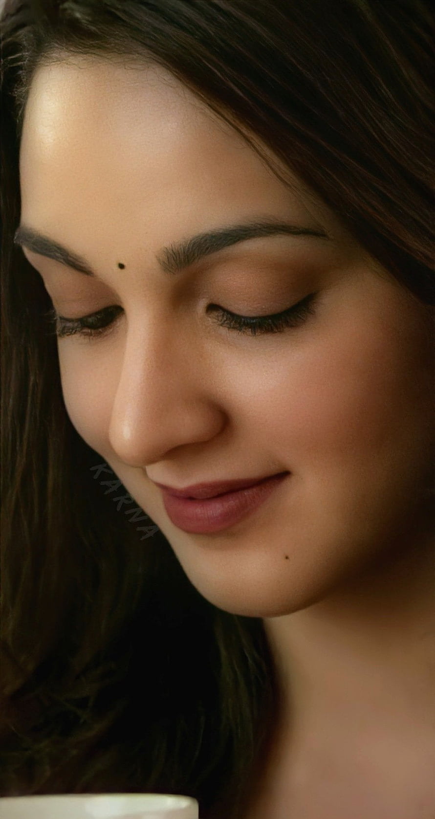 Close-up portrait of a woman with closed eyes and a gentle smile, featuring a bindi and soft makeup, Kiara advani, Kiara_Advani HD phone wallpaper