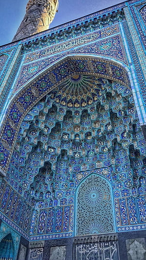 Intricate Blue Tilework and Muqarnas Vaulting on a Historic Islamic Mosque Portal HD phone wallpaper