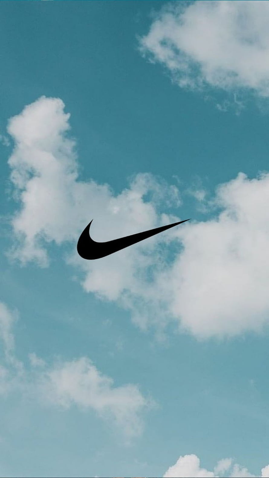 Nike Swoosh Logo Against a Bright Blue Sky with Fluffy White Clouds HD phone wallpaper