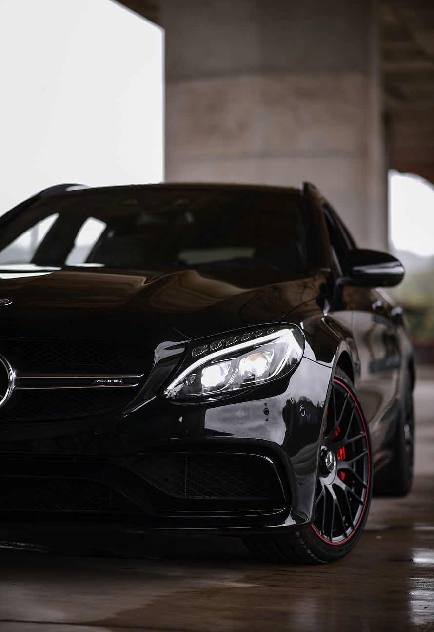 Black Mercedes-Benz C63 S AMG Front Three-Quarter View with Red Accent Wheels HD phone wallpaper
