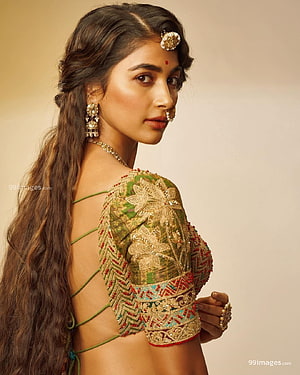 Pooja Hegde in an elegant green embroidered blouse with traditional jewelry and long wavy hair HD phone wallpaper