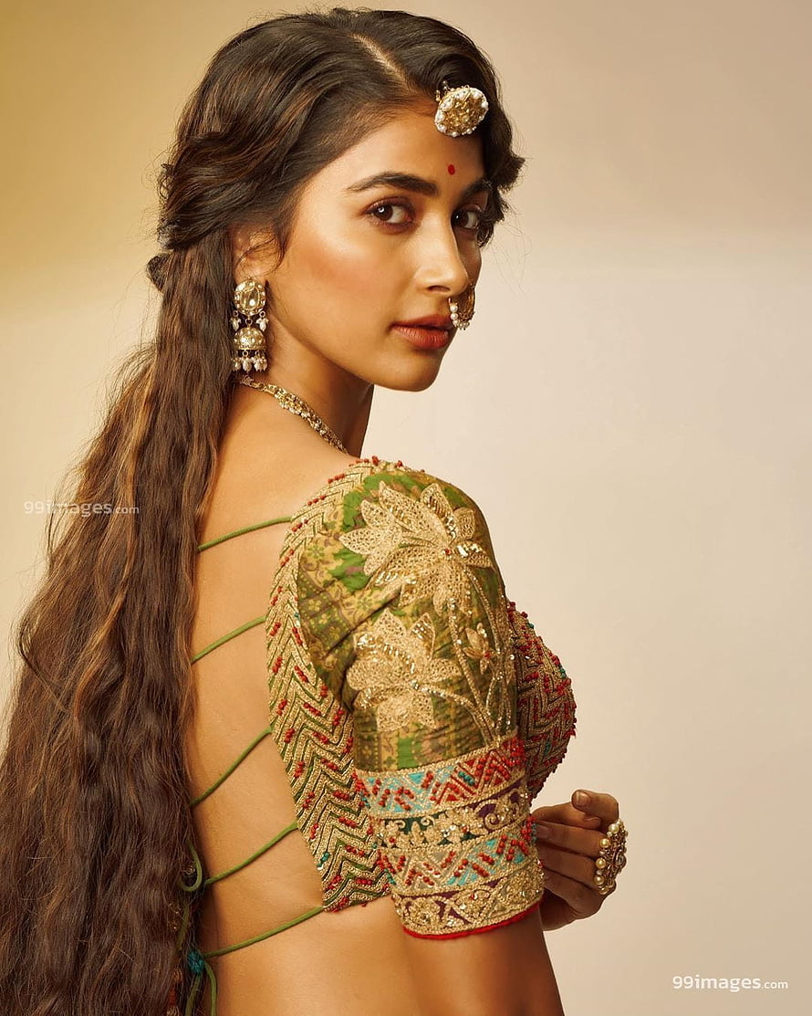 Pooja Hegde in an elegant green embroidered blouse with traditional jewelry and long wavy hair HD phone wallpaper