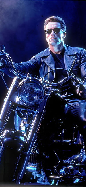 Arnold Schwarzenegger as The Terminator on a Chrome Motorcycle in a Dark Blue Setting HD phone wallpaper