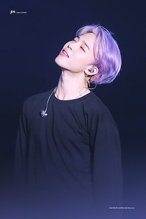 Park Jimin with lavender hair in a black long-sleeve shirt, stage lighting, in-ear monitor, and delicate chain necklace HD phone wallpaper