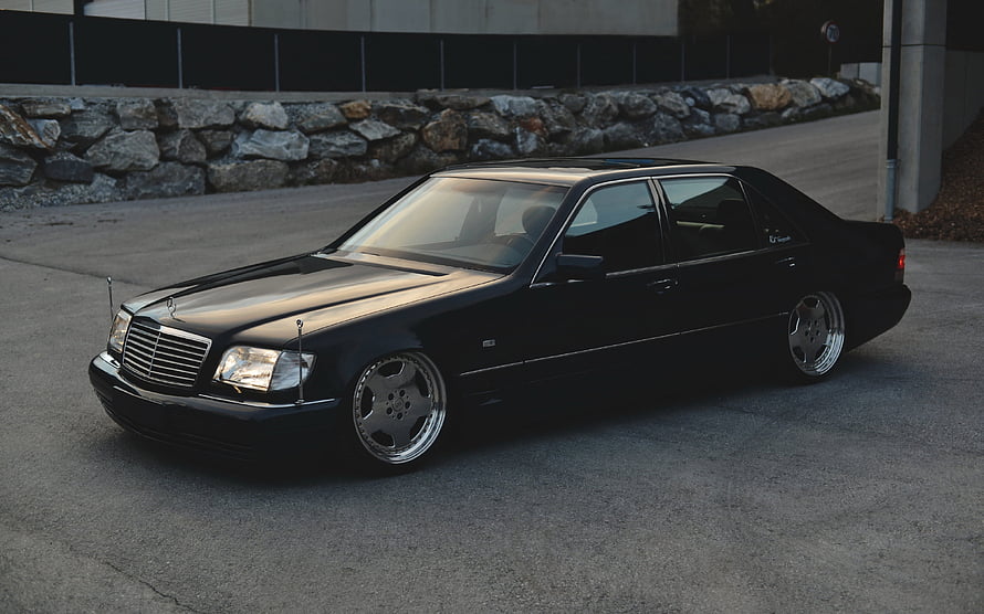 Black Mercedes-Benz W124 S-Class Sedan with Custom Wheels and Lowered Stance HD wallpaper