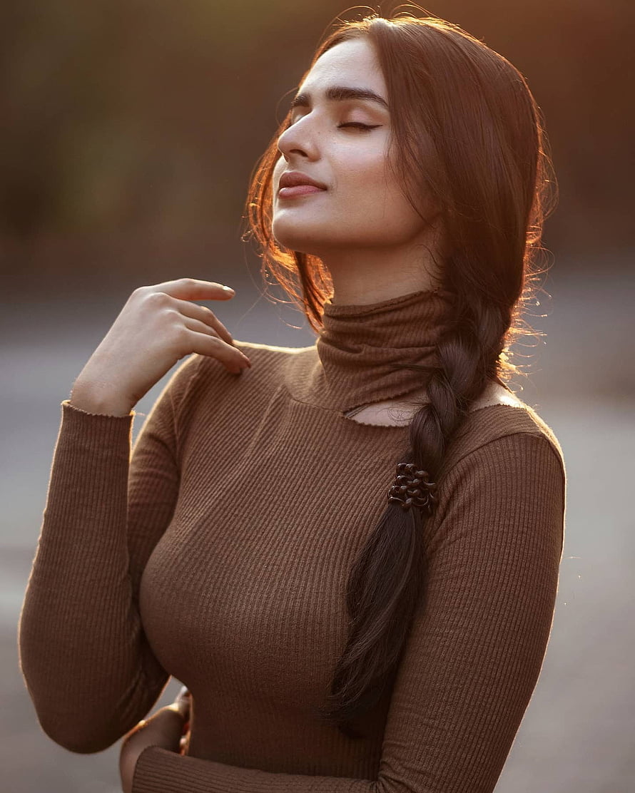 Ayesha Khan Portrait in Brown Turtleneck with Braided Hair and Golden Hour Lighting HD phone wallpaper