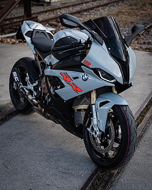 Silver BMW S1000RR Superbike with Red Graphics Parked on Concrete HD phone wallpaper