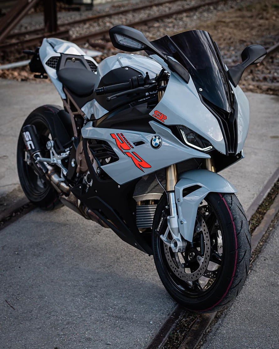 Silver BMW S1000RR Superbike with Red Graphics Parked on Concrete HD phone wallpaper