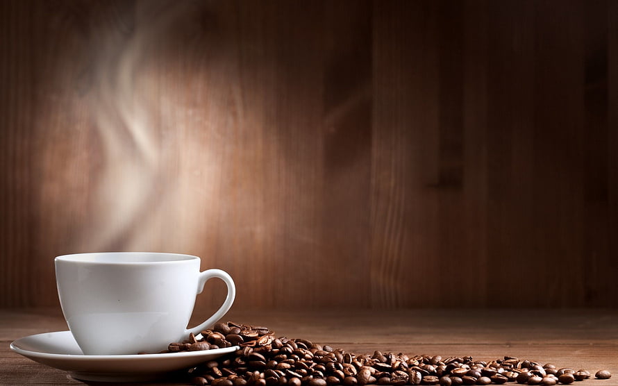 Steaming White Coffee Cup on Wooden Table with Scattered Roasted Beans HD wallpaper