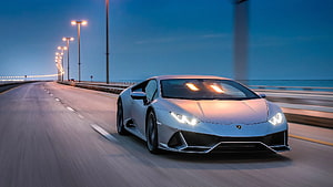 Silver Lamborghini Huracan EVO Cruising on Coastal Highway at Dusk HD wallpaper