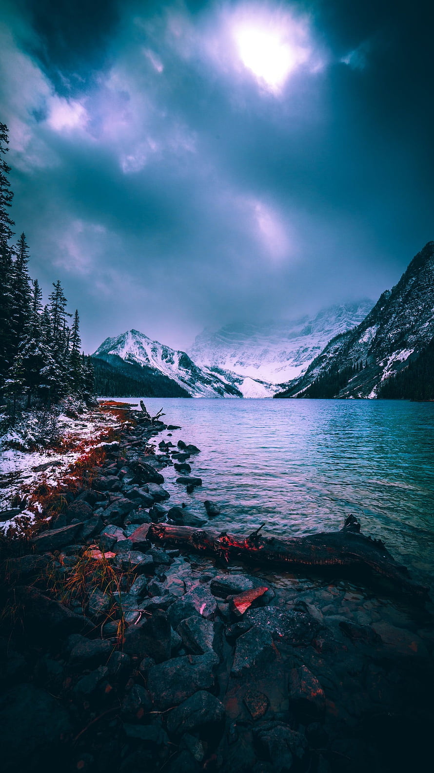 Serene Mountain Lake With Snowy Peaks And Dramatic Cloudy Sky HD phone wallpaper
