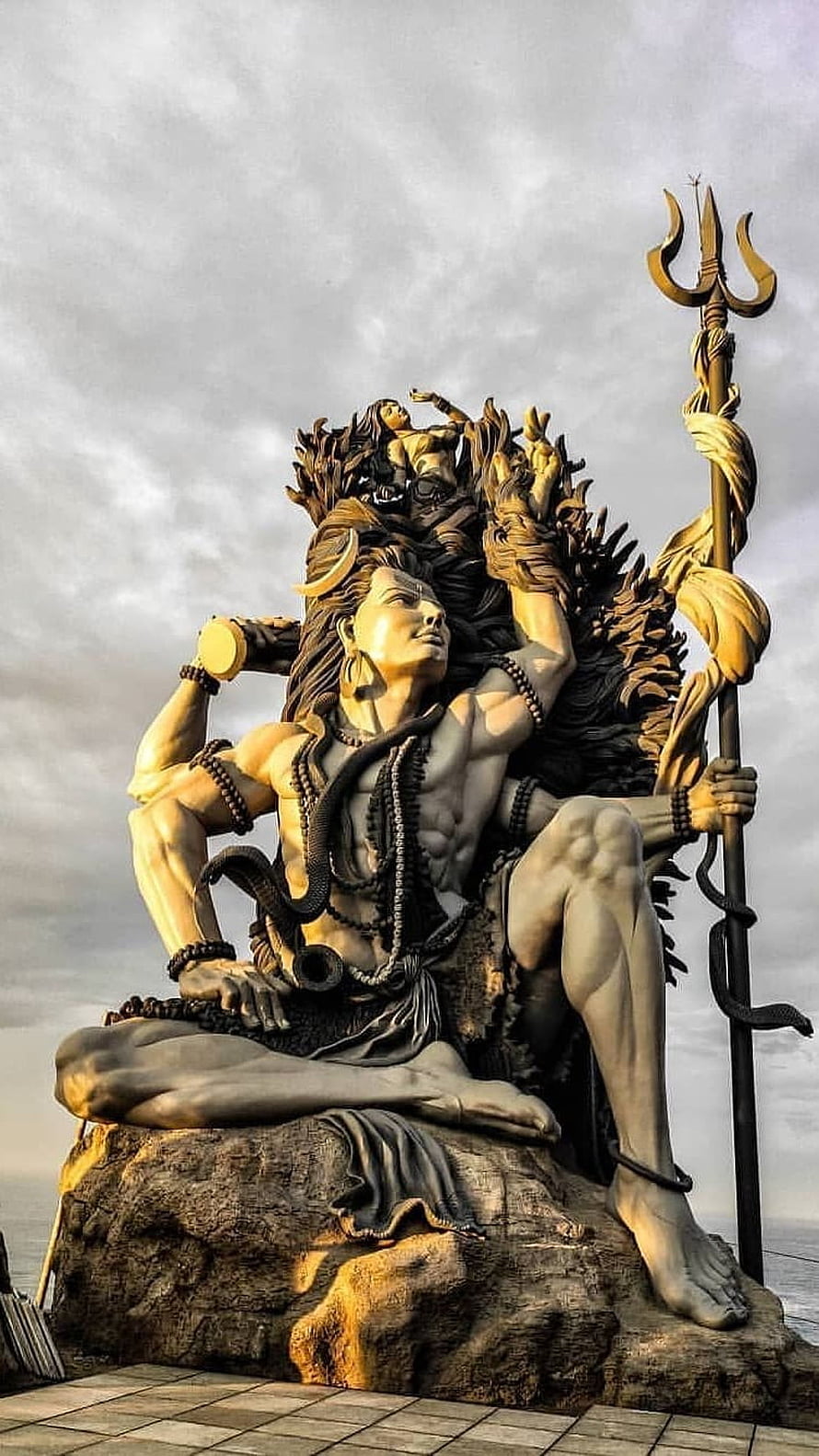 Majestic Shiva Statue in Kerala Temple Setting with Trishula and Serpents HD phone wallpaper