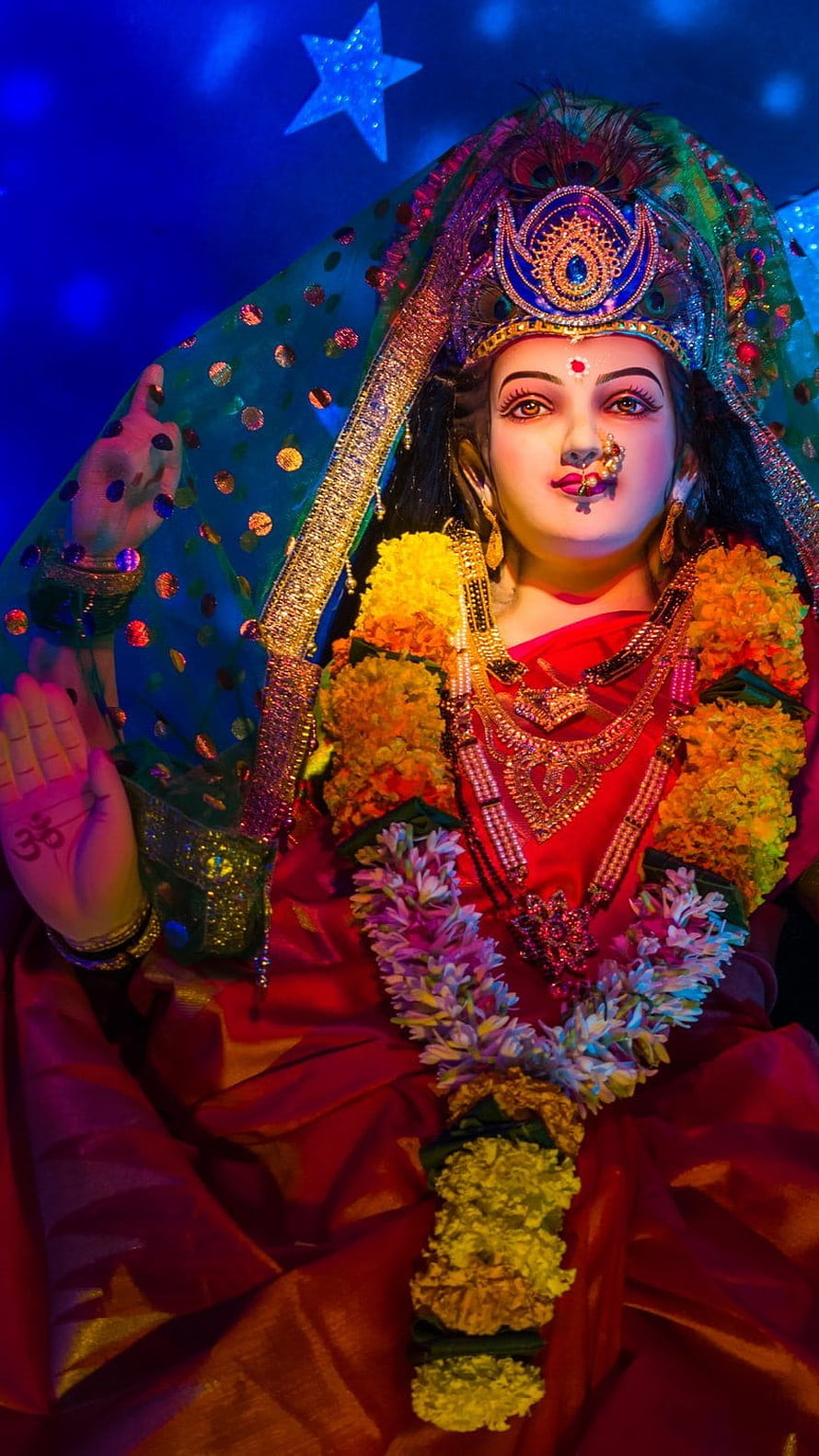 Goddess Lakshmi Statue Adorned with Marigold Garlands and Traditional Jewelry HD phone wallpaper