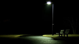 Solitary Park Bench Under a Single Street Lamp in the Deep Night HD wallpaper