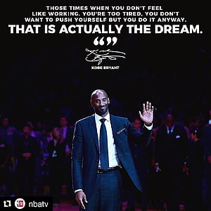 Kobe Bryant in a dark suit waving to the crowd with an inspirational quote overlay HD phone wallpaper