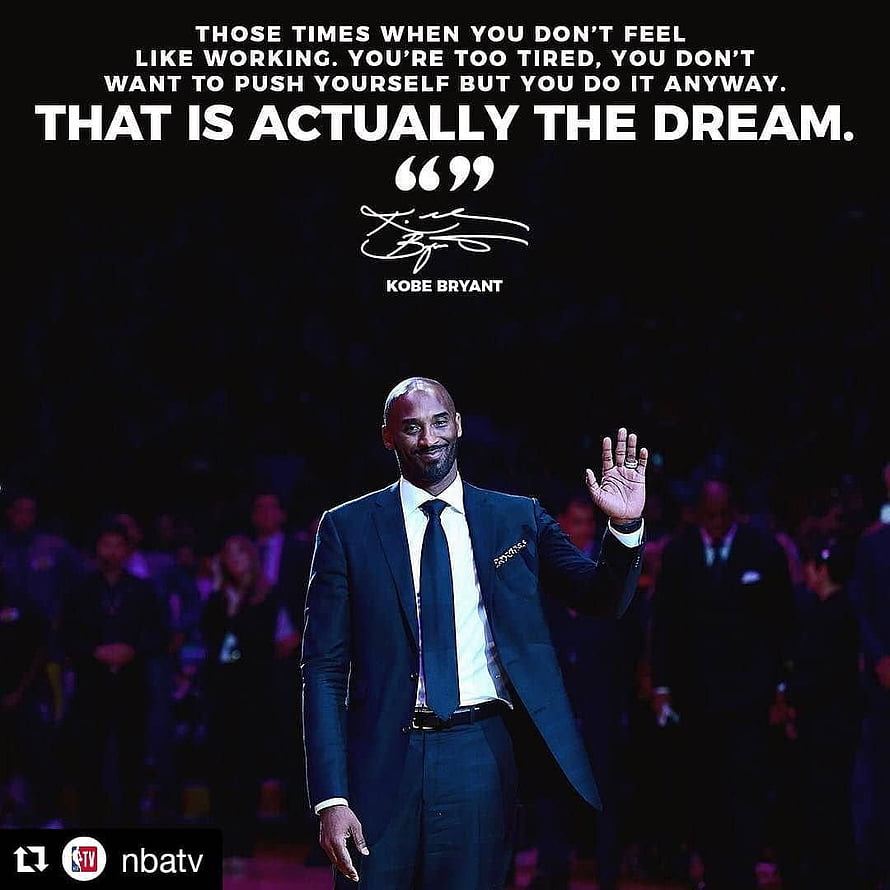 Kobe Bryant in a dark suit waving to the crowd with an inspirational quote overlay HD phone wallpaper