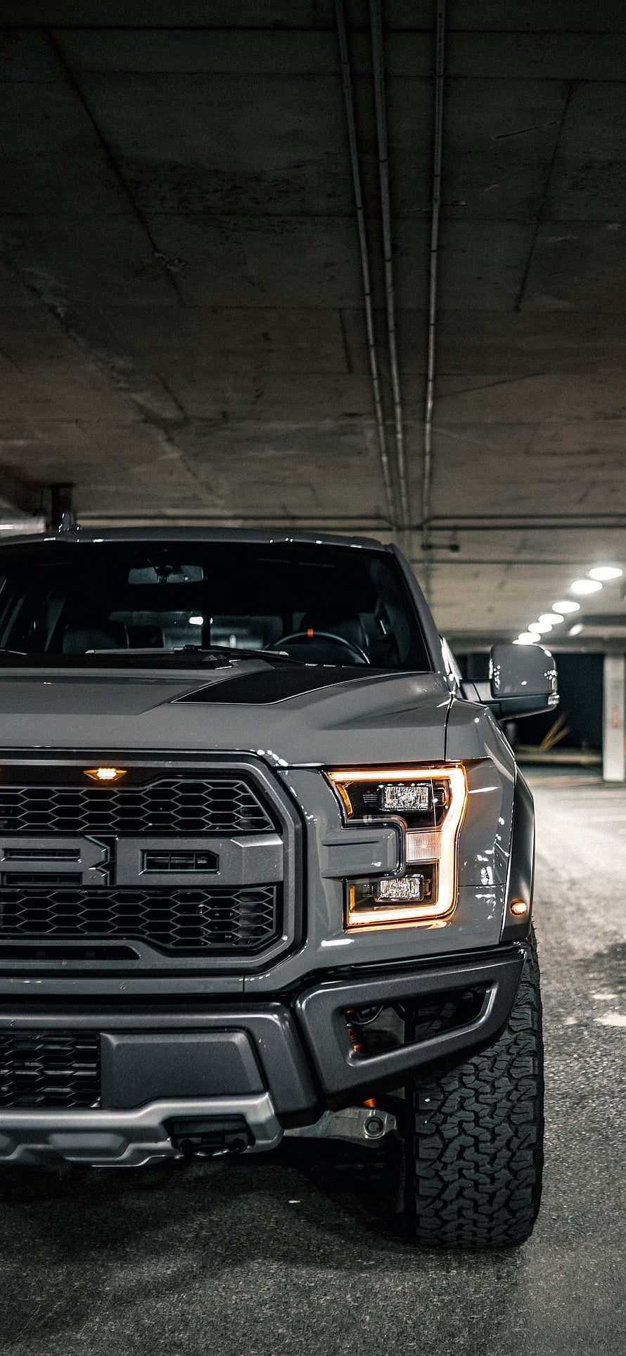 Front View of a Grey Ford F-150 Raptor in a Concrete Parking Garage HD phone wallpaper