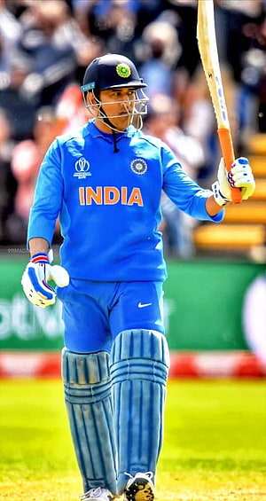MS Dhoni in India Cricket Jersey Holding Bat on the Field HD phone wallpaper