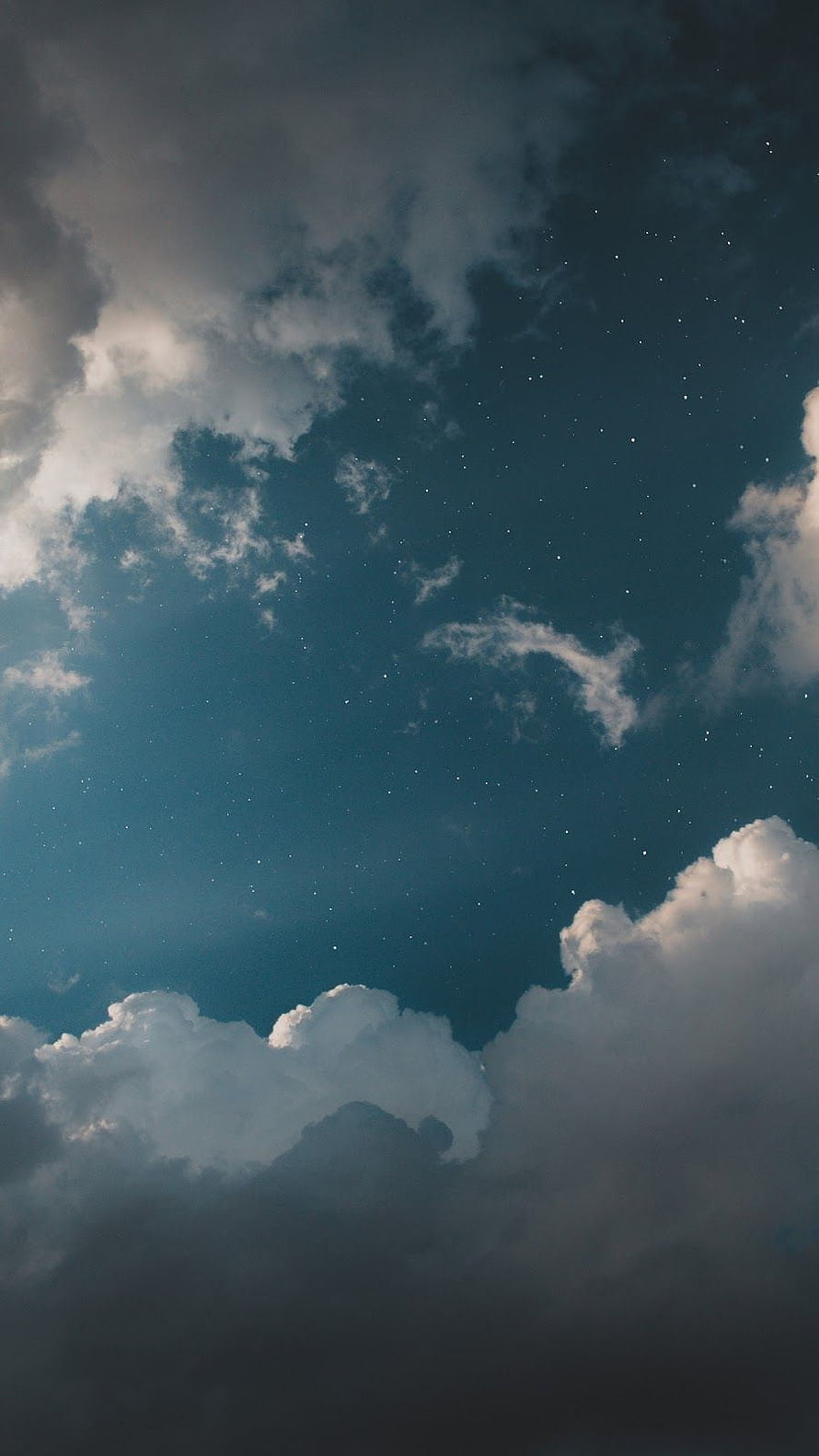 Starry Night Sky with Dramatic Clouds and Deep Blue Atmosphere HD phone wallpaper
