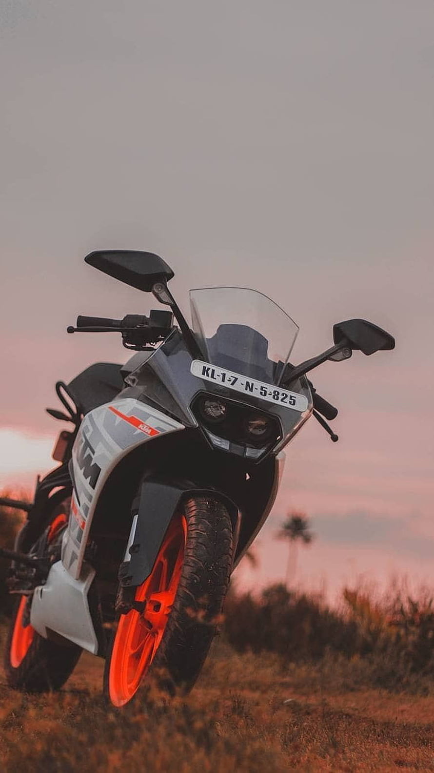 KTM Duke 200 motorcycle with orange wheels parked in a field at sunset HD phone wallpaper