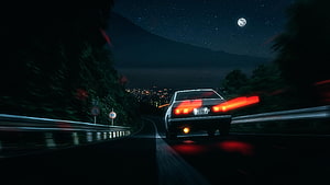 Night Drive on Mountain Road with City Lights and Moon HD wallpaper