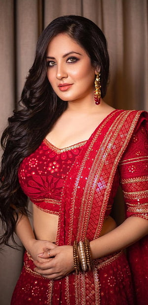 Hina Khan in a stunning red embroidered lehenga choli with gold jewelry and traditional bangles HD phone wallpaper