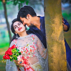 Romantic Couple in Traditional Attire Sharing an Intimate Moment by a Tree with Red Roses, Best Love Couple DP Pics (Stylish, Cute, Romantic, etc) HD wallpaper