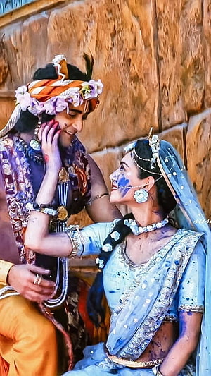 Radha and Krishna in traditional attire sharing a romantic moment with floral jewelry and blue skin, Radha Krishna Serial , Holi, Love, Radha Krishna HD phone wallpaper