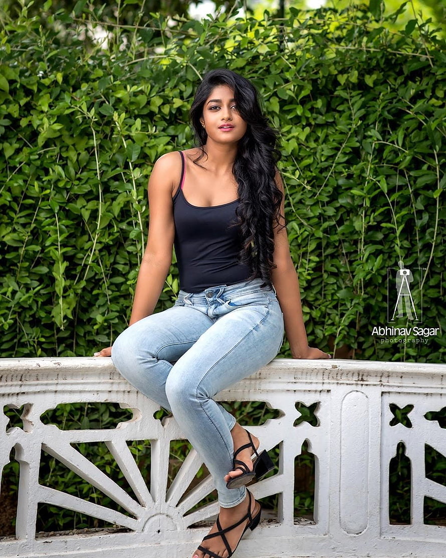 Dimple Hayathi in Black Tank Top and Light Blue Jeans Sitting on White Balustrade HD phone wallpaper