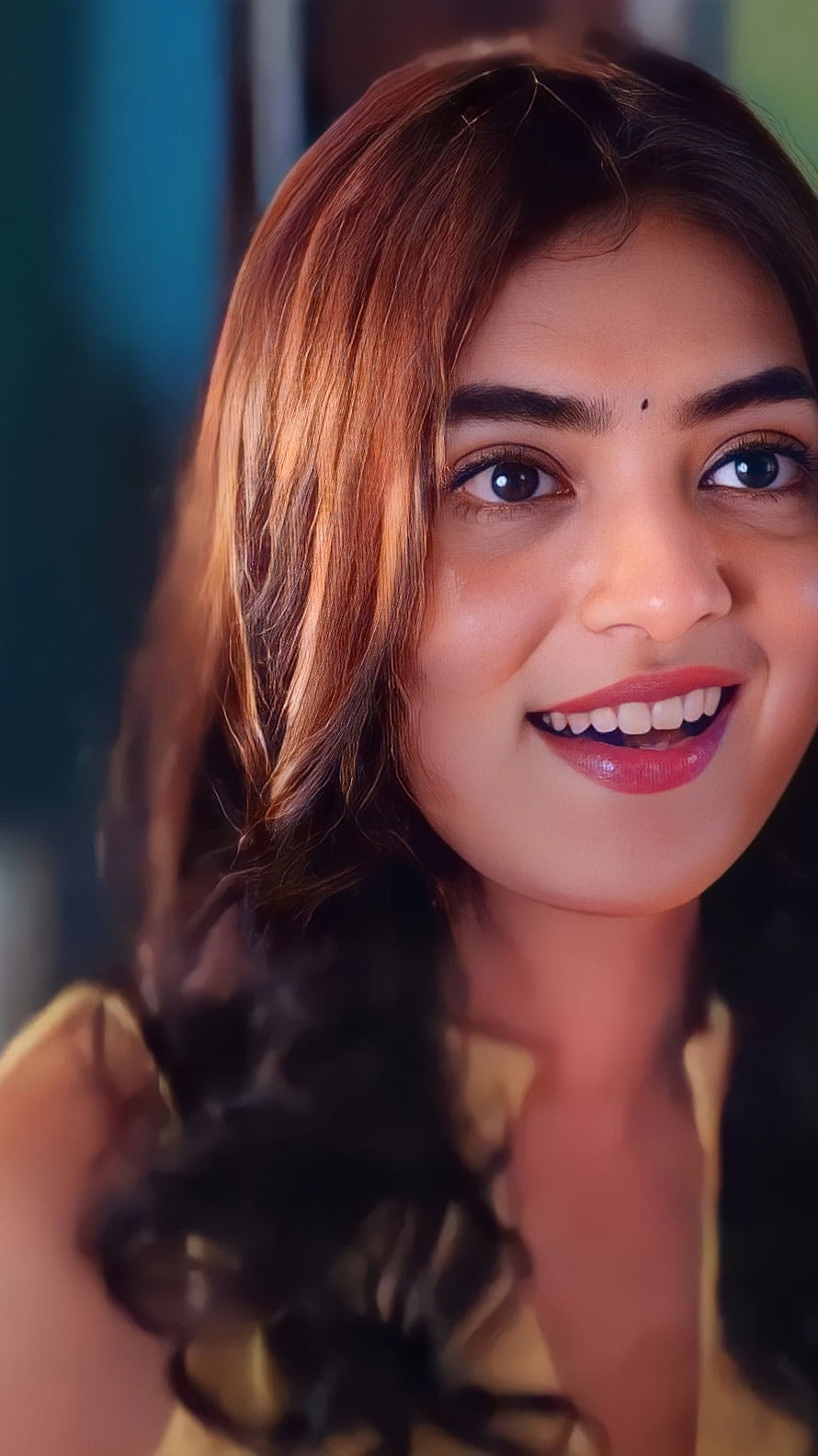 Nazriya smiling portrait with long wavy hair and warm golden lighting HD phone wallpaper